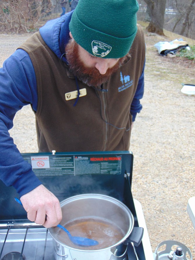 Steve Golobic, an Assistant Miller at Colvin Run Mill in Great Falls, stirs a batch of boiling sap from a maple tree during a Maple Syrup Boil Down talk on Sunday, Feb. 5, 2017.
