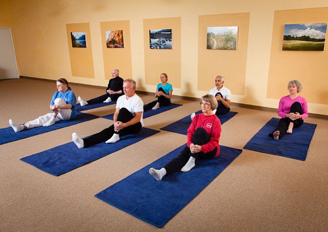 Small group class at Yoga in Daily Life. Pavana muktasana is the knee to body, seated variation pose. 