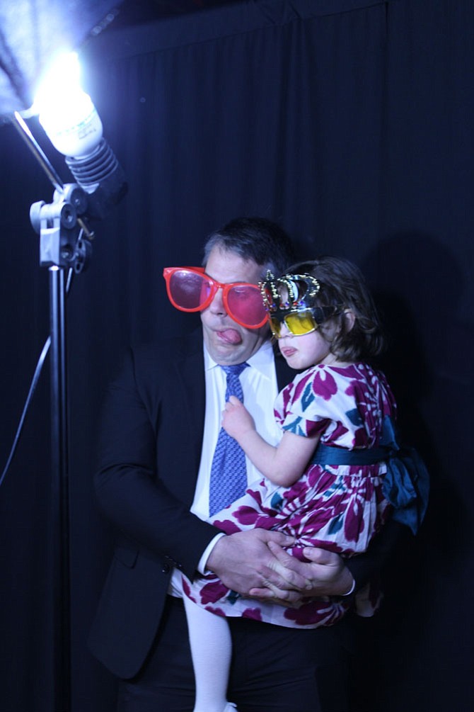 Jason Wenrich holds his daughter Amelia, 4, for a goofy photoshoot at the photo booth.