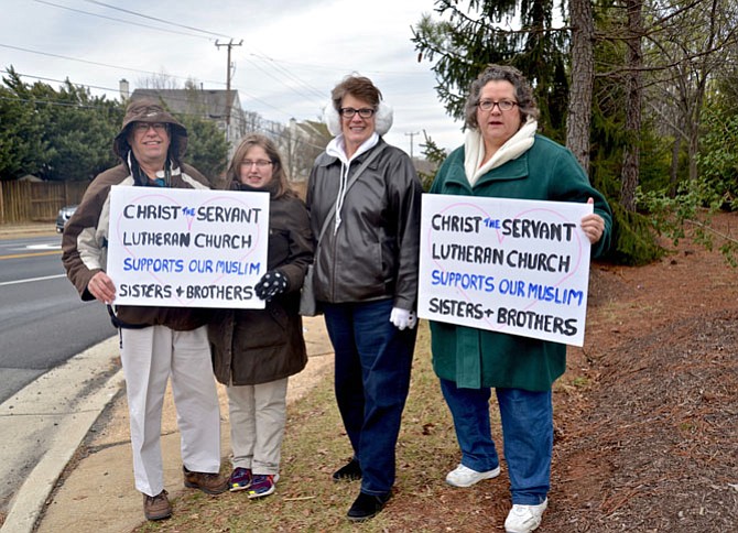 From left -- Bruce Bailey of Centreville, Julia Persing of Reston, Janet Rider of Centerville and Jolene McNamara of Herndon, all members of Christ the Servant Lutheran Church in Reston, show their support for their “Muslim brothers and sisters” at the entrance to the ADAMS Center during the Friday Peace Rally.
