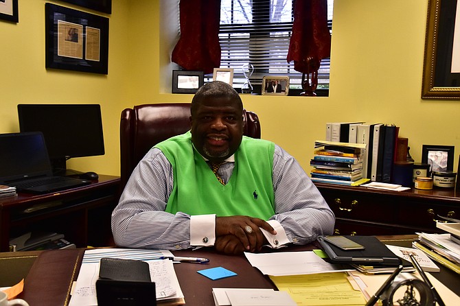 Reverend Dr. Vernon C. Walton sits at his desk. He has been the pastor of the First Baptist Church of Vienna for three years. 