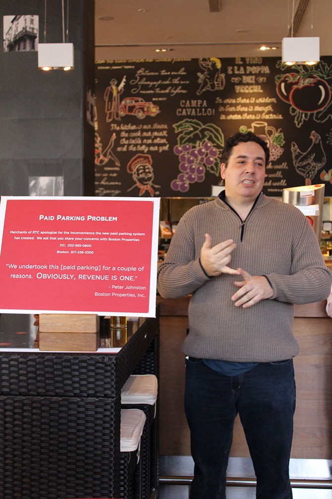 Aaron Gordon of Gordon Food Group and the proprietor of the Red Velvet Cupcakery on Democracy Drive, is one of the merchants who is leading the charge against Boston Properties. He encouraged all the merchants to display this red sign in their windows, which says, “Paid Parking Problem: Merchants of RTC apologize for the inconvenience the new paid parking system has created.” 
