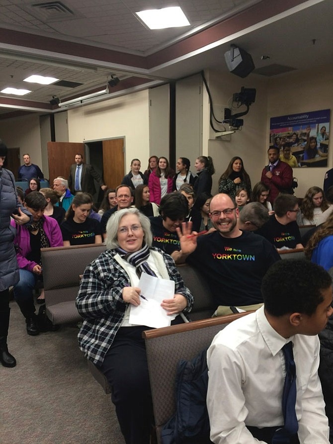 Michelle Buehlmann, a parent, and Aaron Scheultz, Yorktown High School science teacher, attend the school board meeting. Buehlmann, a former Republican staffer, said the educational professionals are doing something right: “These signs have had an impact in the school. We would not be here tonight if they hadn’t. They made the Democratic-leaning sudents feel enfranchised, and at the same time the Republican-leaning students still felt empowered enough to speak up.” 