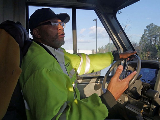 Excell Hart heads to Sunset Drive from Royal Street with his truck full of new trash cans to be delivered. He says he has been doing this for so long that he is his own GPS. 
