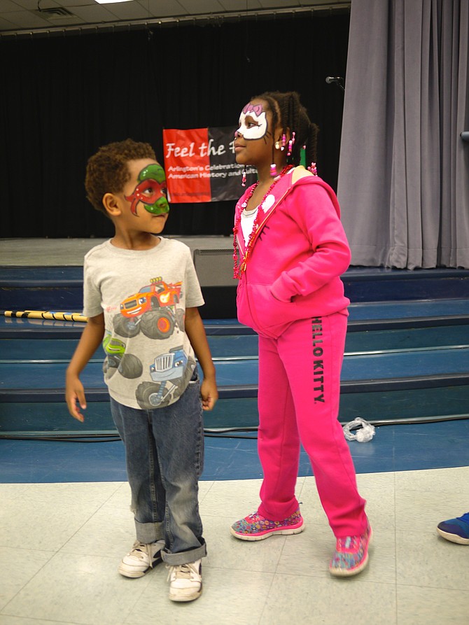 Noah RIchards and his big sister Zoe Richards watch the Capoeira demonstration at Drew Community Center. 
