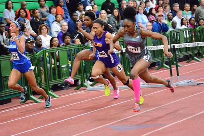 Devyn Jones, on left, competes in the 55-meter hurdles at the 6A State Championship in Hampton.
