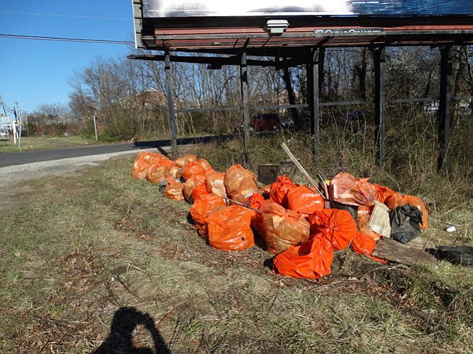 Trash bags are filled with debris pulled from the creek.