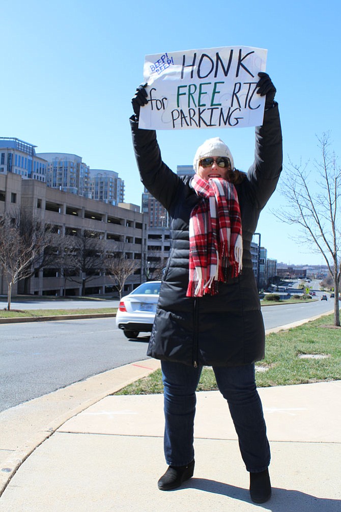 Suzanne Zurn of Reston stands at the corner of New Dominion Parkway and Fountain Drive as protest marchers organize at step off point. Zurn started a Change.org petition against paid parking well before it was implemented in March 2016.
