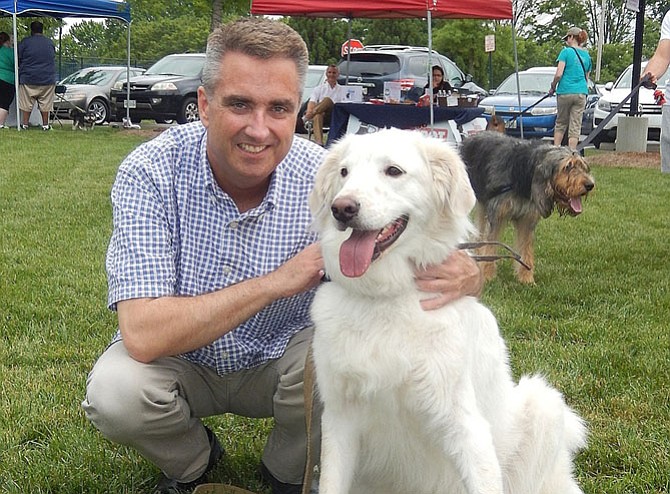 Scott Silverthorne with a friend’s dog during the City’s June 2016 Fido Fest.