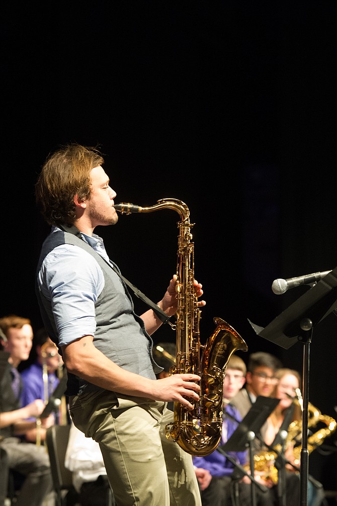 Cory Carter, Chantilly High School senior, performs a solo on the tenor sax with the Chantilly Jazz during its March 23 performance at the Chantilly Invitational Jazz Festival. In the background, seniors Jeremy Rechner, Munis Thahir and Katie Doherty look on.