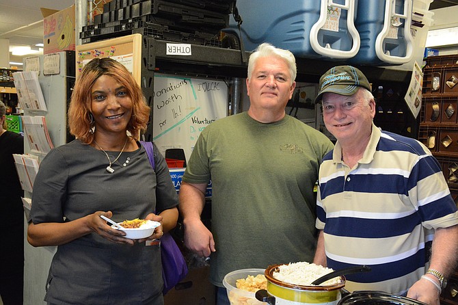 From left, Abibatu Kamara of Lorton samples venison chili from Suburban Whitetail Management’s Tom Dalton of Springfield and Bob Flanagan of Fairfax Station at Lorton Community Action Center. 