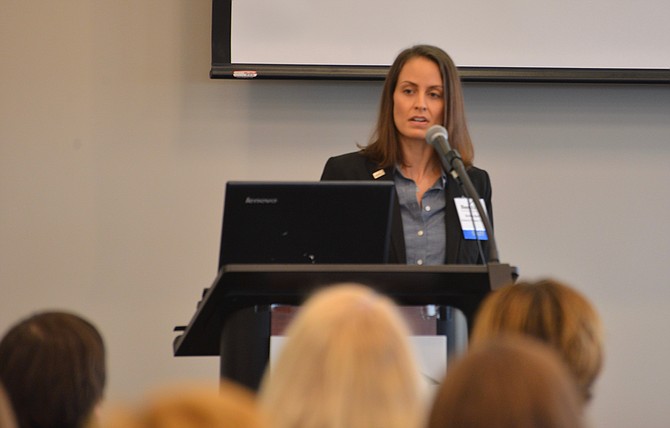 Newly appointed HomeAid Northern Virginia executive director Kristyn Burr welcomes the participants to the organization’s annual Housing Forum for housing and homeless services providers.