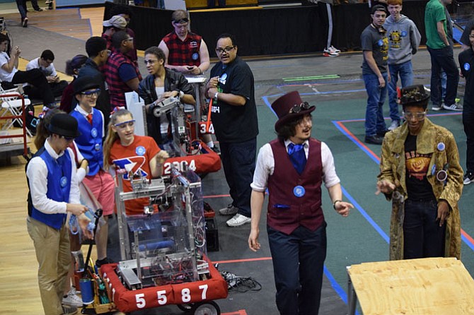 Titan Robotics team members with their robot at the Edgewater competition.
