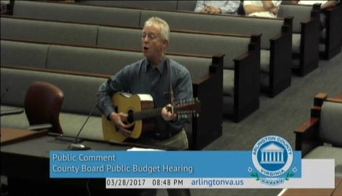 Jeffrey Liteman sings his budget petition to the County Board.