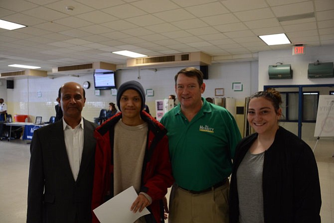 From left, Rokan Ahamed of Burke and his son Yusuf, supervisor Pat Herrity (R-Springfield) and Colleen Burger of West Springfield at the third teen job fair, held April 1 at West Springfield High School.