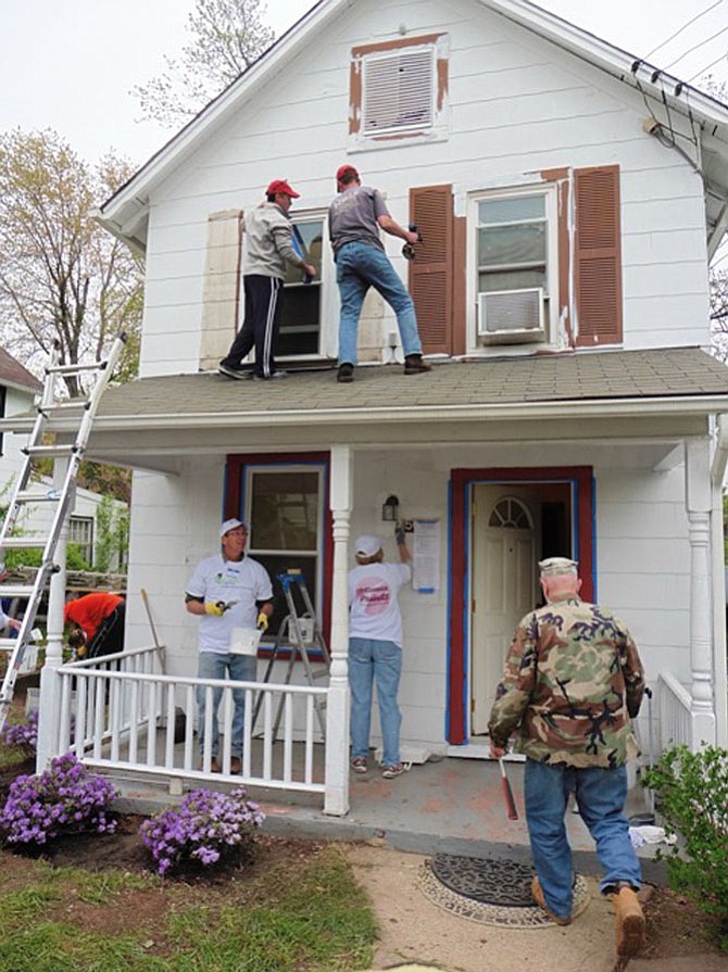 Volunteers work on Cheryl Fludd’s home.