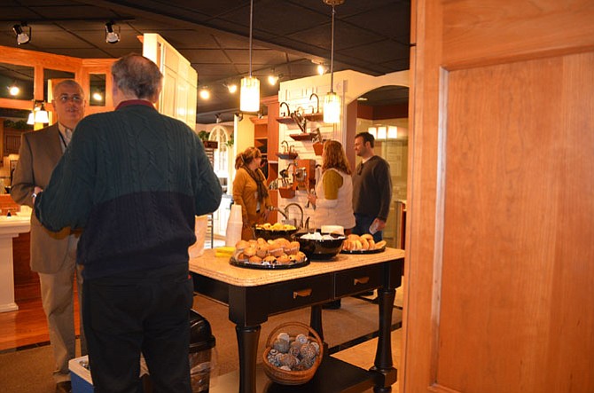 Remodeler David Foster (left) talks with a homeowner browsing in the recently-opened Design and Selection Center, which is holding an Open House on April 22 from 10 a.m. to 5 p.m. The Open House will feature three seminars, access to representatives from major home improvement product manufacturers, a raffle and chef-prepared hors d'oeuvres. 