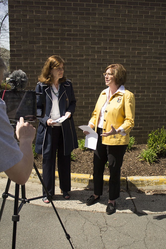 Lisa Connors, a spokesperson for the county, left, interviewed Cornerstones CEO Kerrie Wilson, right, on Facebook Live on Wednesday, April 5, outside the Embry Rucker Shelter in Reston. The video is posted on the Fairfax County Government Facebook page.