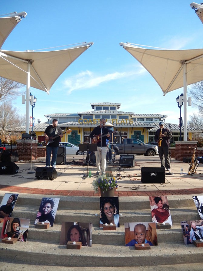 Blue Tango entertains the crowd at the Crime Victims Tribute at Fairfax Corner. In front are photos of local victims. 
