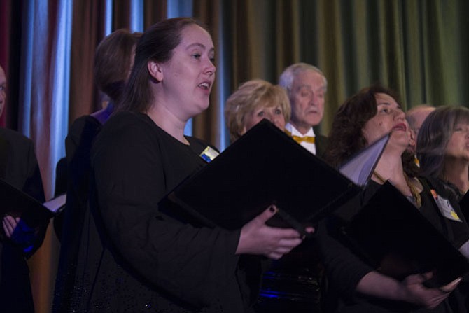 Cheryl Kennedy, a soprano with the Reston Chorale, sings “Feelin’ Groovy” with her fellow Chorale Singers to open the program.