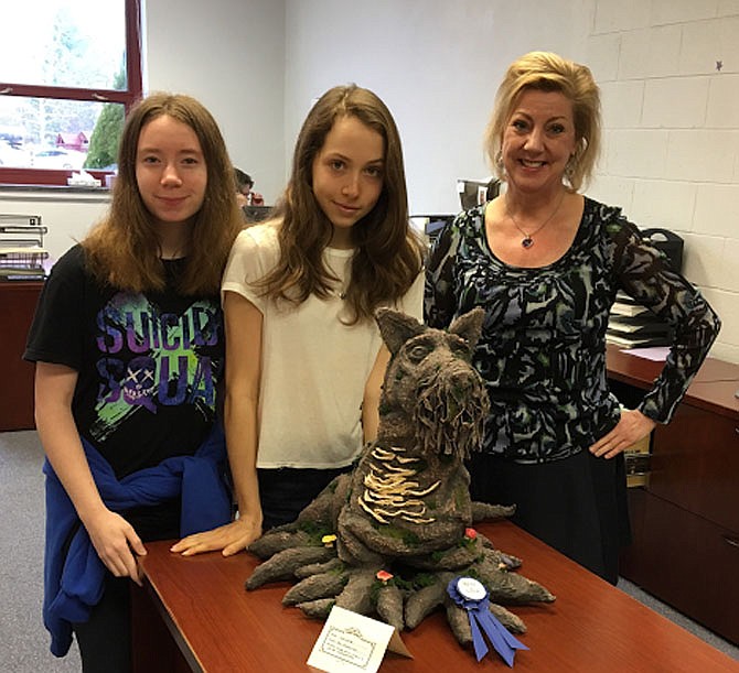 This dog, Juniper, won best in show. Left to right: Students Marguerite Godwin and Julia Johannsen and Administration Assistant Julie Rosenau.