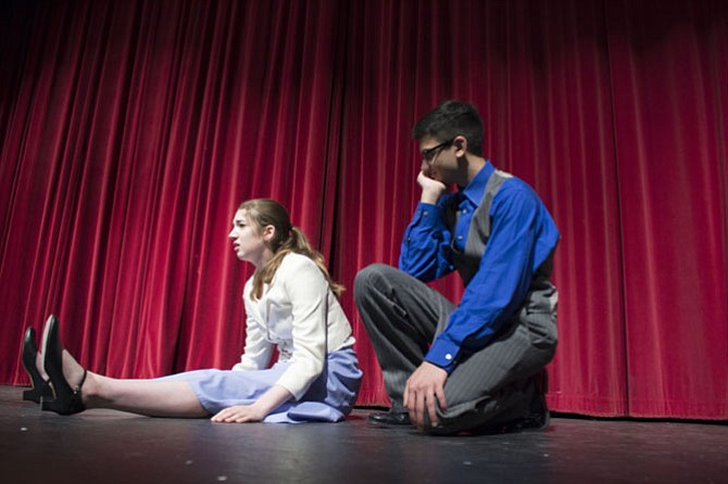 Sarah Brown, played by sophomore Erin Maxwell, 16, and Sky Masterson, played by junior Kishan Rae, 16, exchange lines during rehearsal on Monday, April 17.