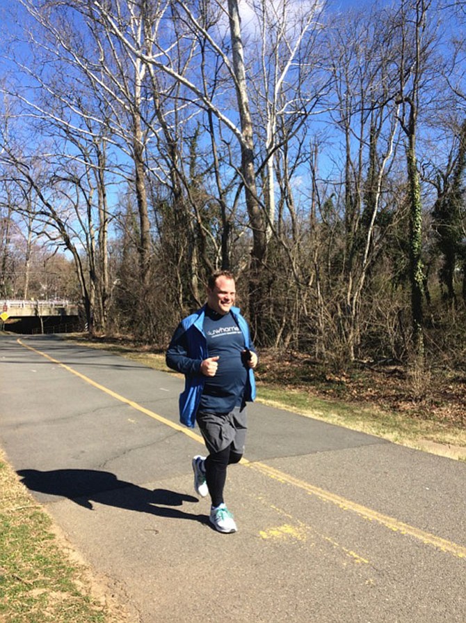 Andrew Schneider coming in with a smile — 5 miler.