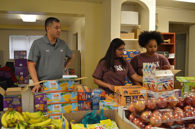 BB&T volunteers Steve Menjivar, Mythri Hanumanthaiah and Erica Lee assemble emergency food backpacks for low income and homeless children April 7 at the Community Lodgings New Brookside Learning Center as part of the BB&T Lighthouse Project.
