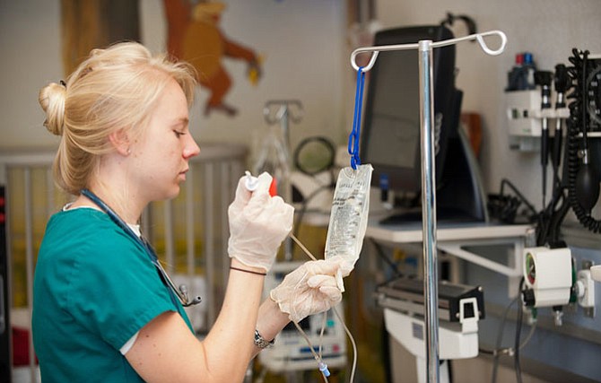 GMU College of Health and Human Services Nursing student Megan Holmes works in the Simulation Lab at the Fairfax Campus. 