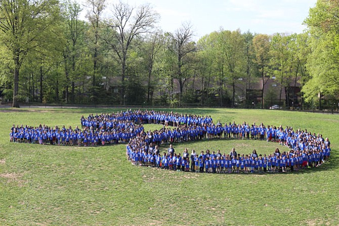 Lake Anne Elementary School students form a giant number 50 in the grass outside of the school while wearing special T-shirts the parent-teacher association bought for them on the day of the celebration.