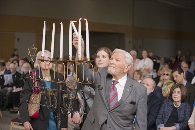 Holocaust survivor Martin Finkelstein lights a candle during the Holocaust Remembrance event at Washington Hebrew Congregation’s Julia Bindeman Suburban Center.