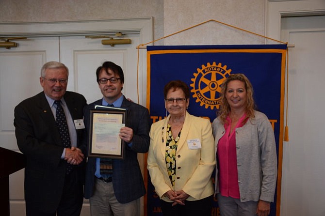 From left, Rotarian Mike Becraft, Ravensworth Elementary School counselor Todd Austin, club president Estela Landeros and Ravensworth principal Roxanne Salata.