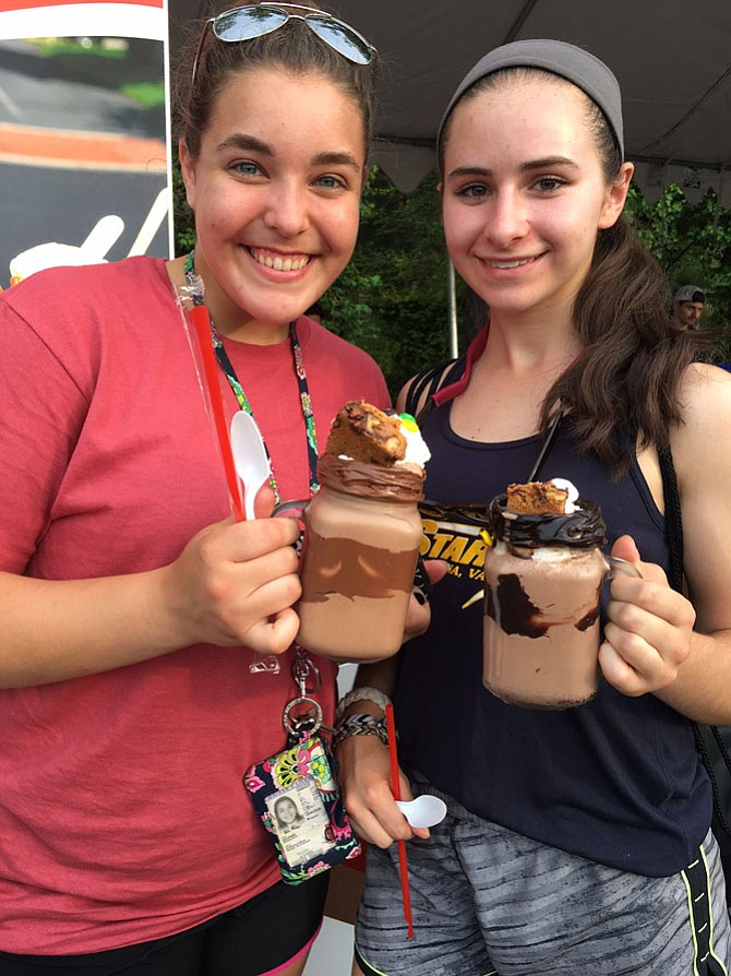 From left: Madison High School students Abbie Bolinger and Nicole Adkins said their Kustard & Co. decadent floats were worth the $10 per drink charge. Bolinger pulled out the candy bar from her “nutty Nutella” to start the imbibing process while Adkins studied her “dirty brownie” for a few moments.