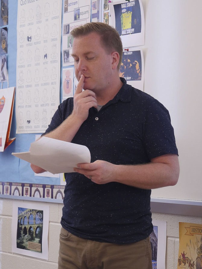 Justin Redpath, Latin teacher at T.C. Williams High School, “gets down in the dirt” with his class on analyzing Roman poems — what is the author trying to say and how does it translate into our lives today.