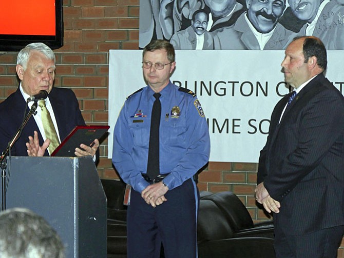 Andres Tobar, president of Arlington County Crime Solvers (ACCS), and Arlington County Police Chief Jay Farr present the ACCS Law Enforcement Officer of the Year award to Detective Kevin White.