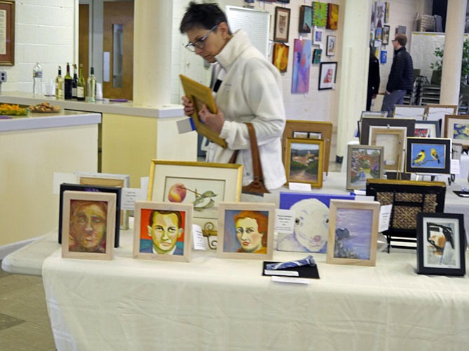 Susan Penny looks over the artwork for sale.

