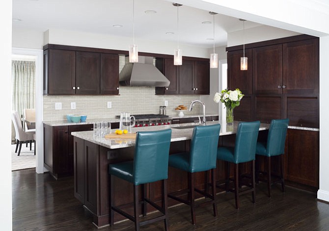 This Arlington kitchen by WINN Design + Build includes Wellborn Premier cherry wood cabinetry and custom-stained solid oak hardwood floors. Added workspace allows for easy meal prep and is ideal for entertaining.