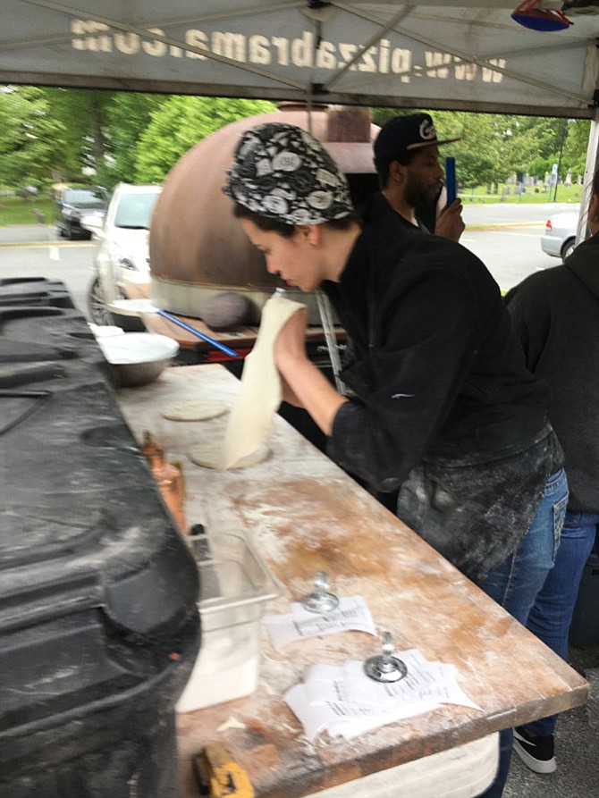 Jordan Chacon prepares pizza crust at Pizza Brama, one of several vendors at Potomac Village Farmers Market. The market is open Thursdays from 2-6:30 p.m. in the parking lot of Potomac United Methodist Church at the intersection of Falls Road and Democracy Blvd.