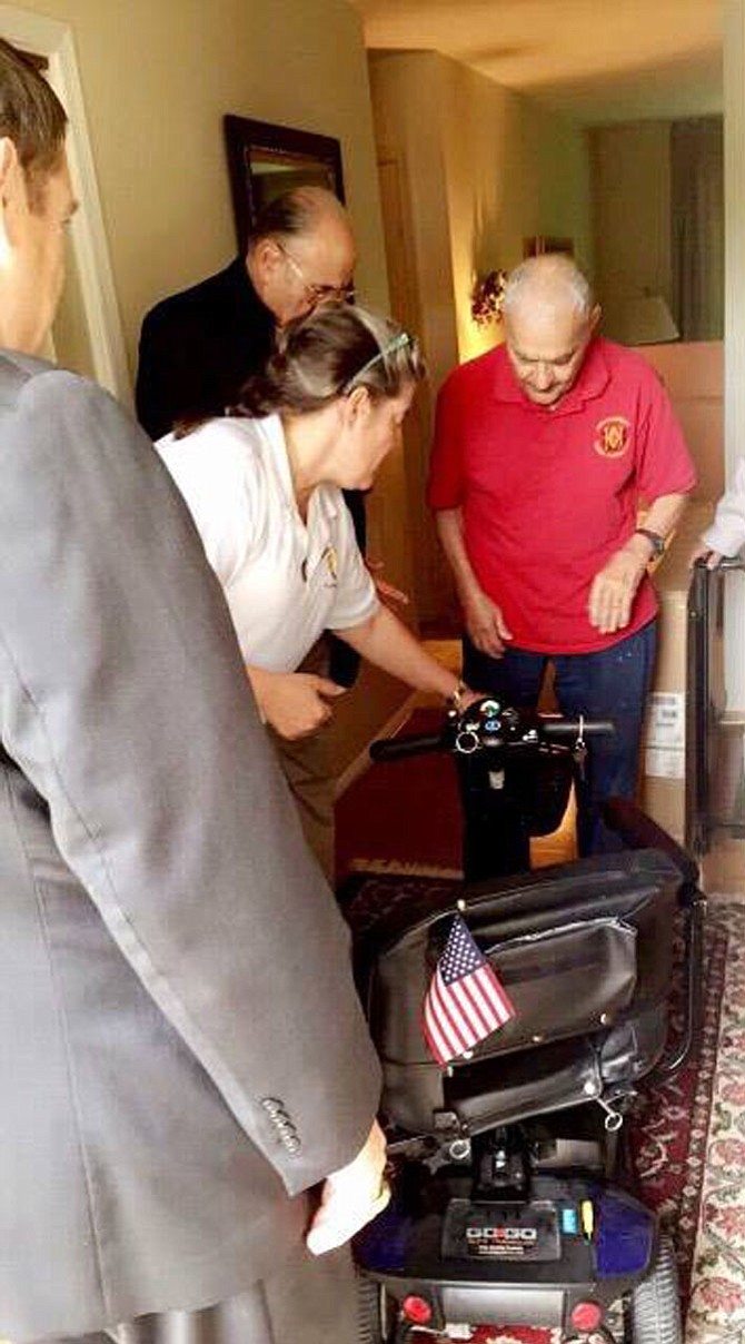 On May 7, Lt. Col. Nick Perriello (right) received a motorized scooter wheelchair from Germaine Broussard (left) and the non-profit organization she founded called TroopTreats.