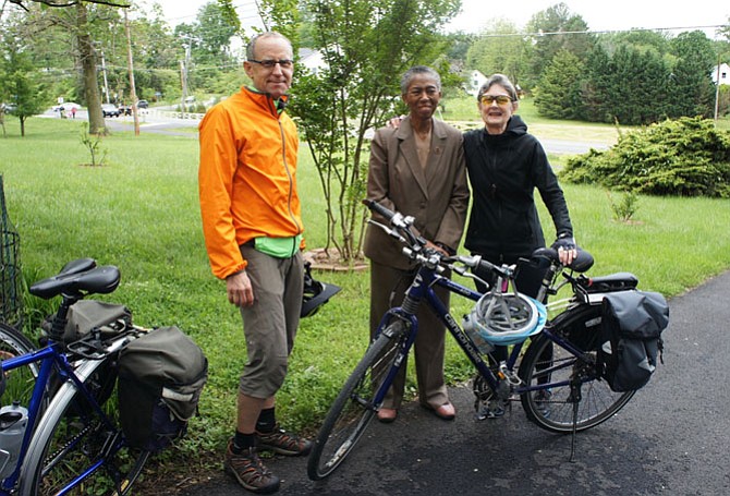 Fairfax County Supervisor Cathy Hudgins (D-Hunter Mill), center, waits with Bruce Wright and Kerie Hitt, for the Beulah Road Walkway project ribbon-cutting event to begin. Wright and Hitt demonstrated the connectivity improvements of the project by biking from Reston to the ceremony in Vienna.