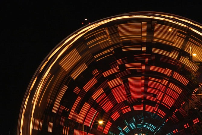 At night, the spinning wheel lights up the sky.