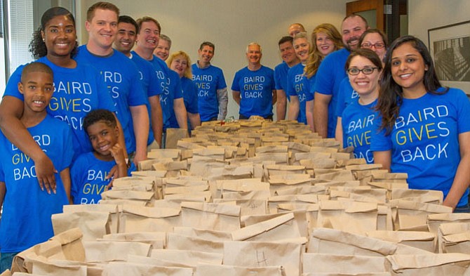 Photo contributed by Chase Hinderstein/The Wise Investor Group
<cl>The associates of The Wise Investor Group at Robert W. Baird & Co. take a moment after assembling more than 200 lunch kits for the residents and clients at the Embry Rucker Shelter in Reston, as part of Baird Gives Back week.