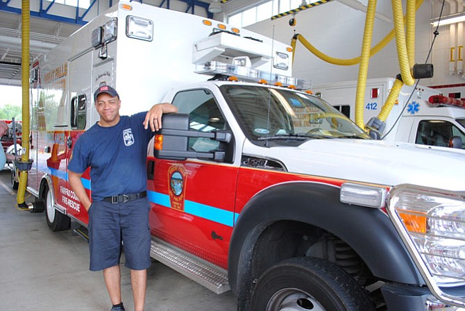 Michael Moore, Master Technician, stands by one of the ambulances he drives.