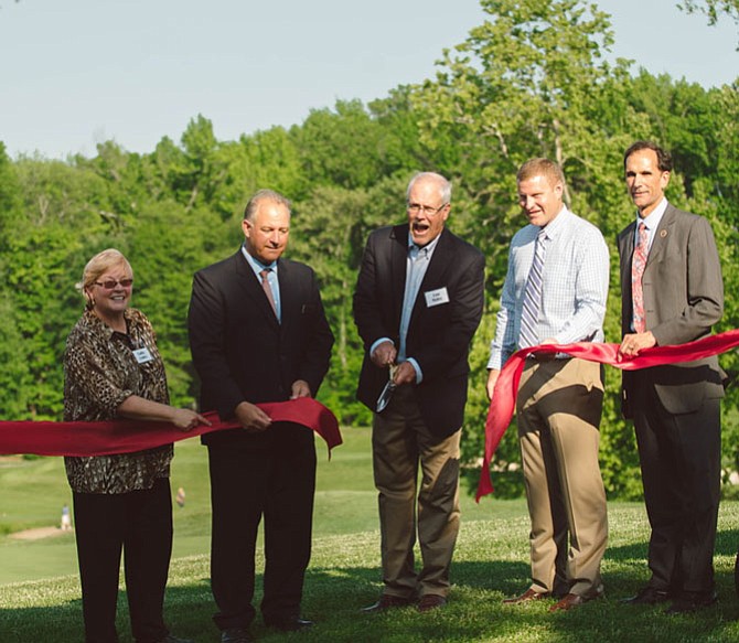 Those helping to cut the ceremonial ribbon upon the opening of Mount Vernon Country Club’s eco-friendly golf course include MVCCA’s Cathy Ledec (from left), club General Manager Pete Van Pelt, club President Lou Haley, Supervisor Jeff McKay (D-Lee), and Supervisor Dan Storck (D-Mount Vernon).