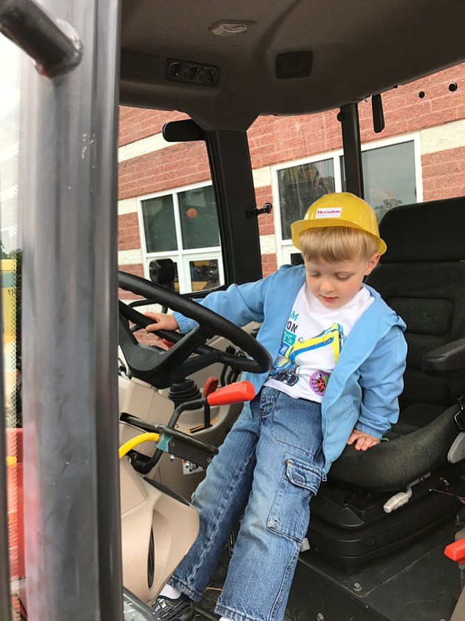 Until he can reach the pedals a little bit better, Scott Anderson, 3, may have to wait a few more years before he joins the ranks of the skilled men and women of Herndon’s Department of Public Works.