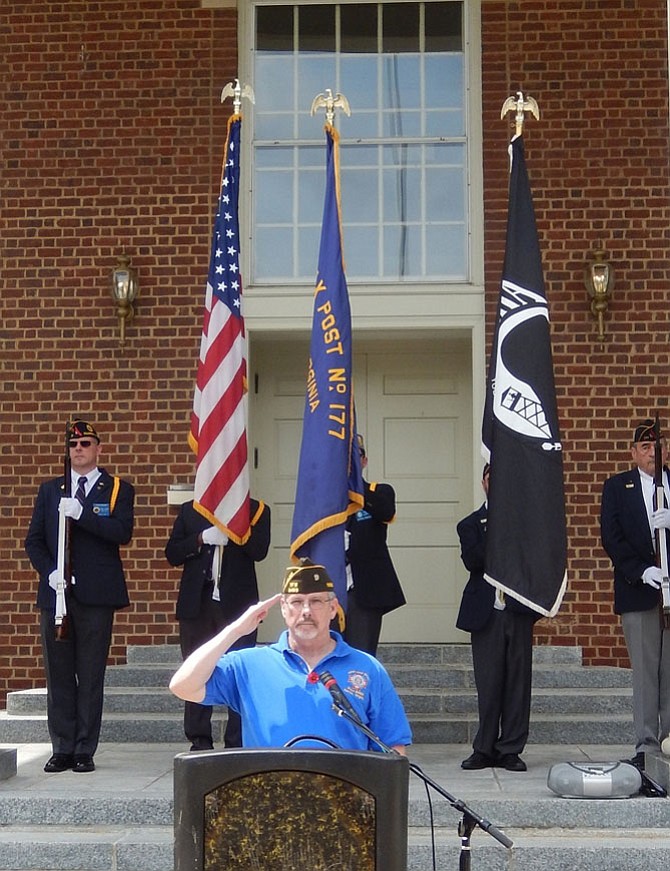 Veteran Mac McCarl salutes at the end of the ceremony.
