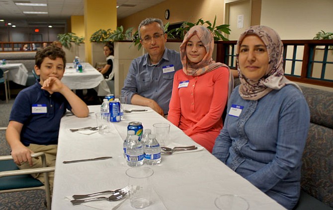 The Kilic family of Vienna, from left, Cemal, Erdal, Yasemine and Emine, at the American Turkish Friendship Association Ramadan Iftar dinner at the Government Center.
