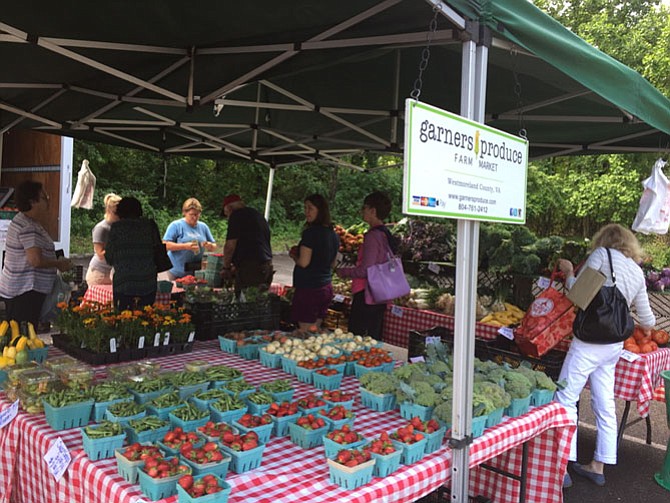 Shoppers line up at Garner’s Produce for fresh fruits and vegetables. 