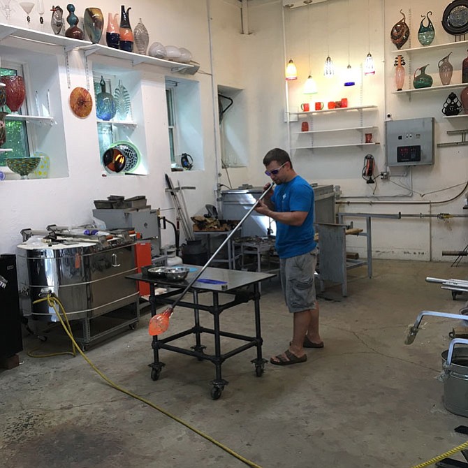 Philip Valencia demonstrates the art of glassblowing during the Folklore Society of Greater Washington Folk Festival on Sunday.