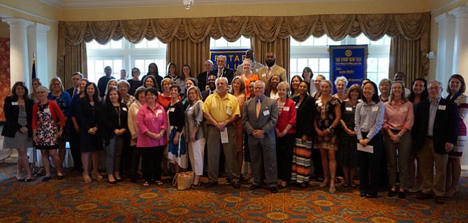 Representatives from 46 social service and nonprofit organizations gather for a group photo after receiving grants totaling $108,000 from the Rotary Club of Alexandria June 6 at Belle Haven Country Club.